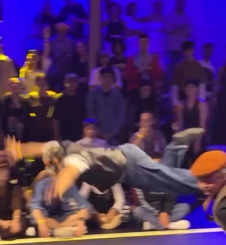 A breaker mid-move at a packed dance battle